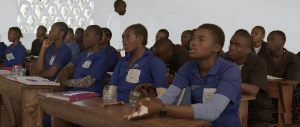 A full classroom of secondary pupils in Cameroon following the lesson